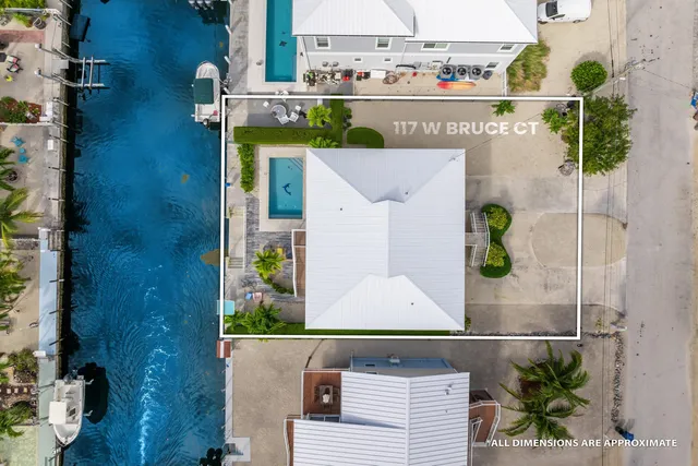 an aerial view of residential houses with outdoor space and swimming pool