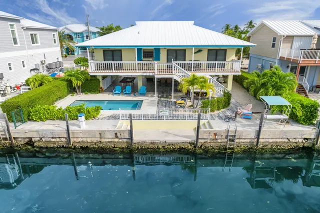 a view of a city from a balcony with furniture