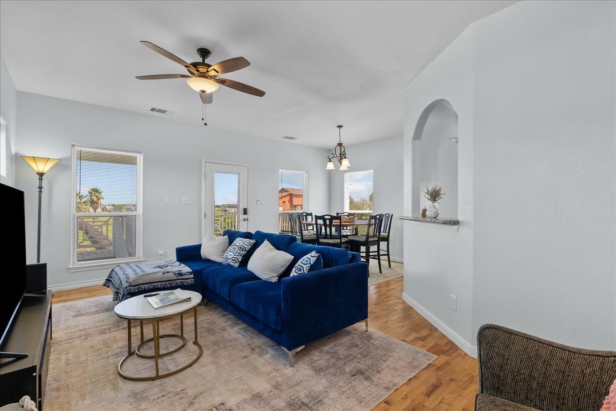 1012D 22nd Street, Unit D Dickinson, TX 77539 - Photo 11 of 44 a living room with furniture a rug and a chandelier