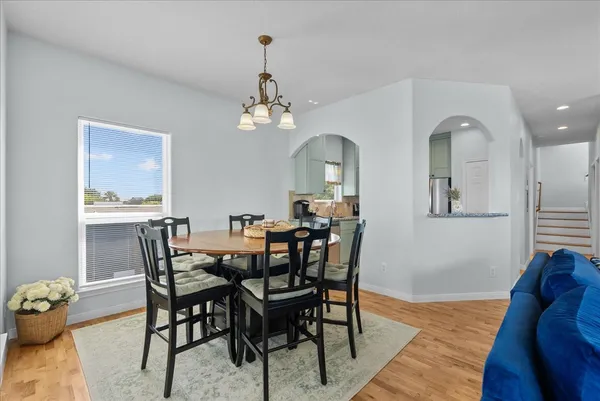 a view of a dining room with furniture and chandelier