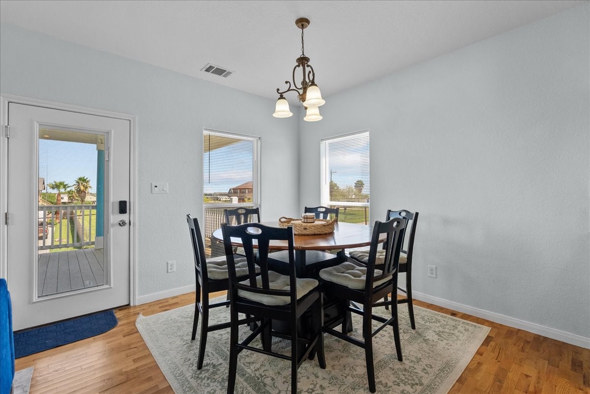 1012D 22nd Street, Unit D Dickinson, TX 77539 - Photo 15 of 44 a view of a dining room with furniture wooden floor and chandelier