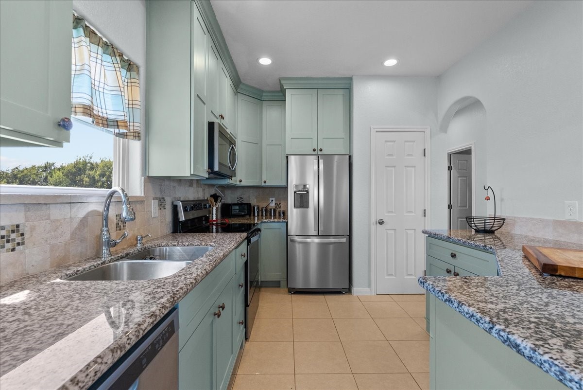 1012D 22nd Street, Unit D Dickinson, TX 77539 - Photo 16 of 44 a kitchen with a sink refrigerator and microwave