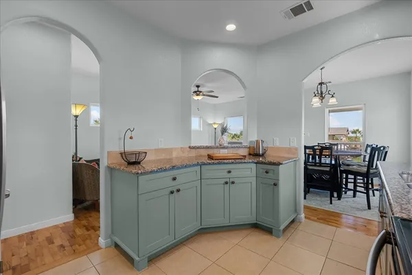 a large kitchen with kitchen island a sink table and chairs