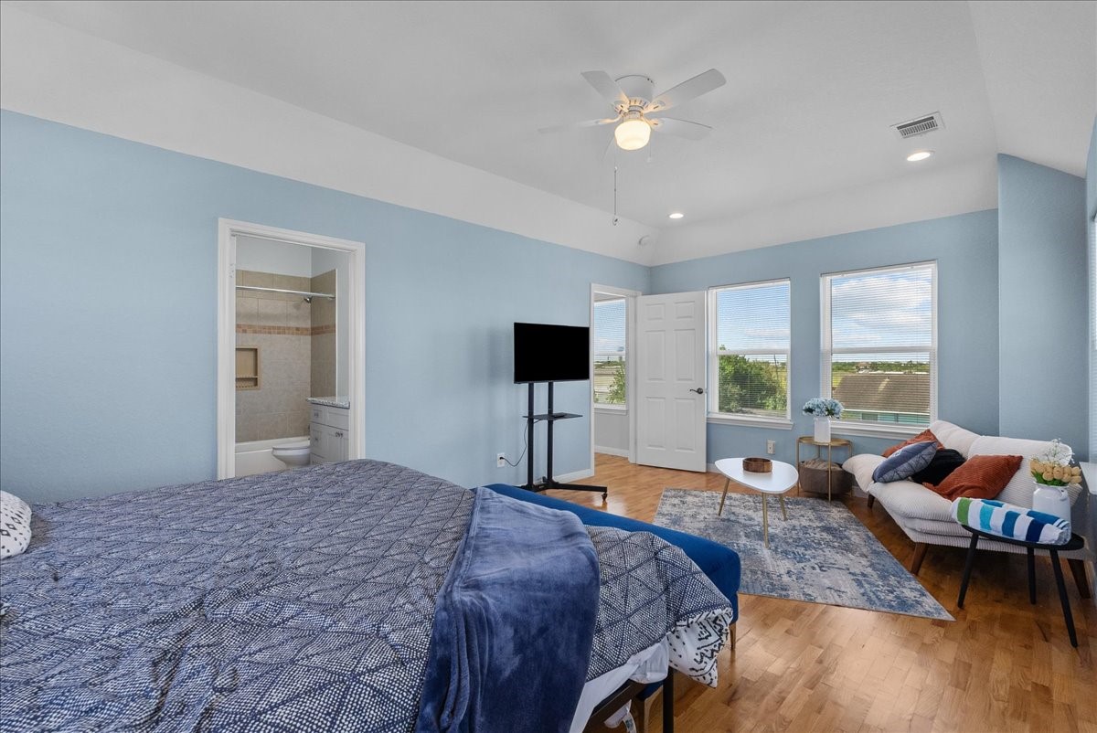 1012D 22nd Street, Unit D Dickinson, TX 77539 - Photo 20 of 44 a bedroom with a bed and wooden floor