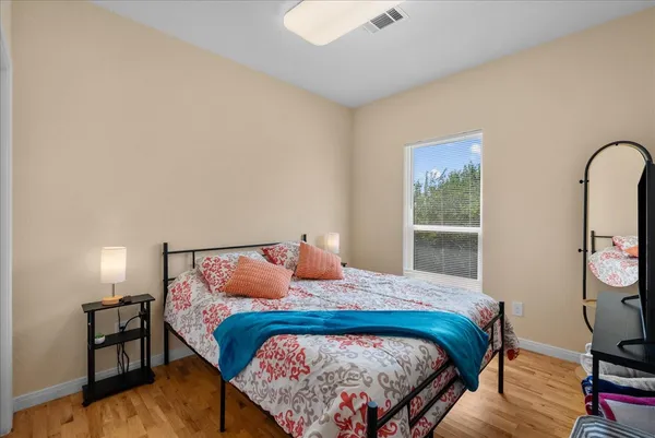 a bedroom with a bed and a tv on table