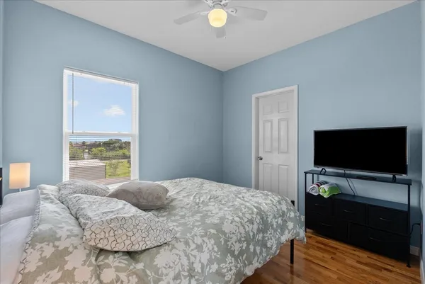 a bedroom with a bed and a flat screen tv