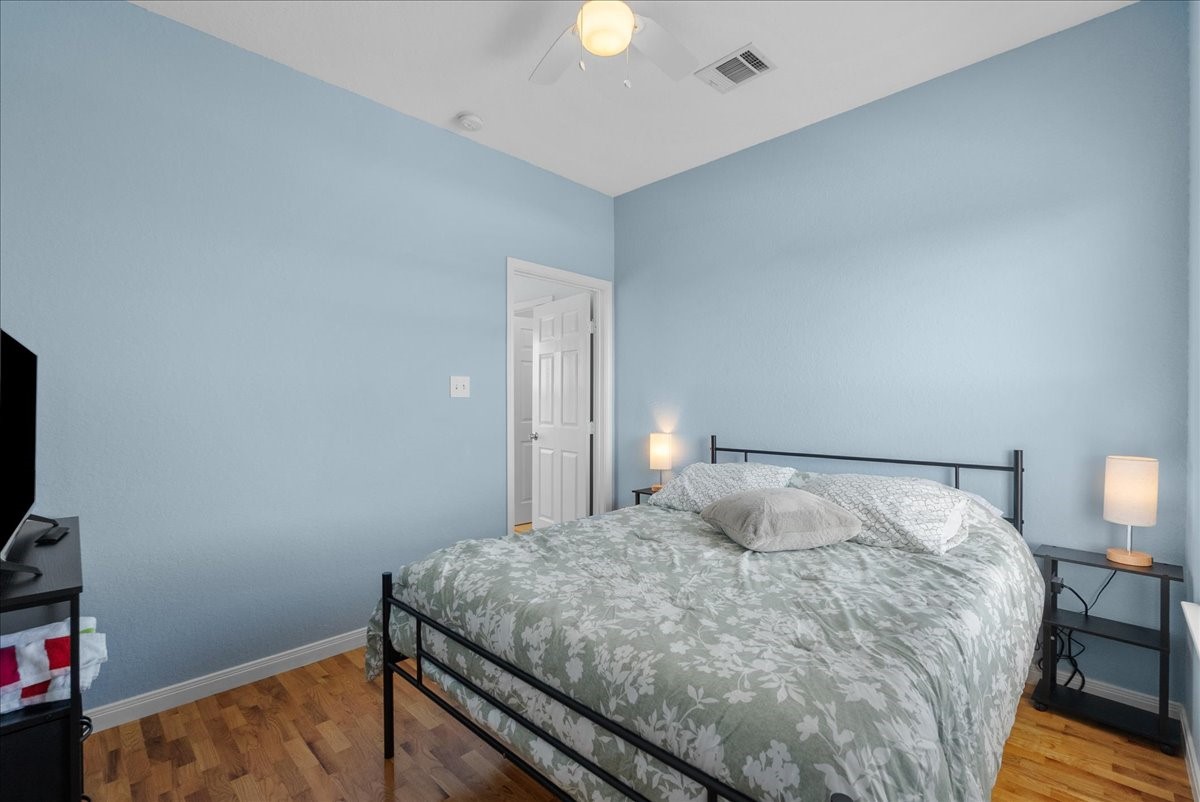 1012D 22nd Street, Unit D Dickinson, TX 77539 - Photo 28 of 44 a bedroom with a bed and a flat tv screen on a dresser