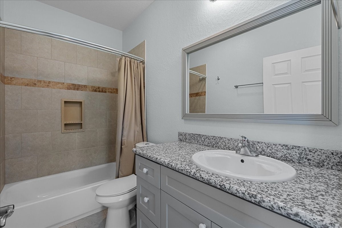 1012D 22nd Street, Unit D Dickinson, TX 77539 - Photo 29 of 44 a bathroom with a sink and a mirror