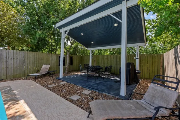 a view of a patio with table and chairs
