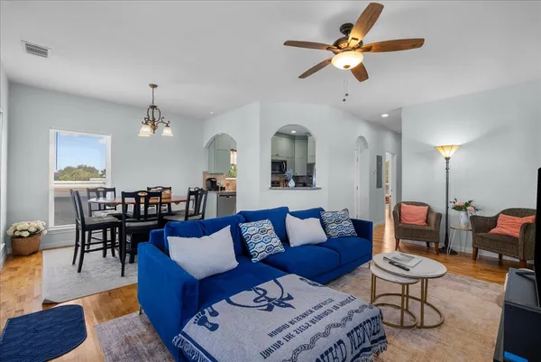 a living room with furniture a rug and a chandelier