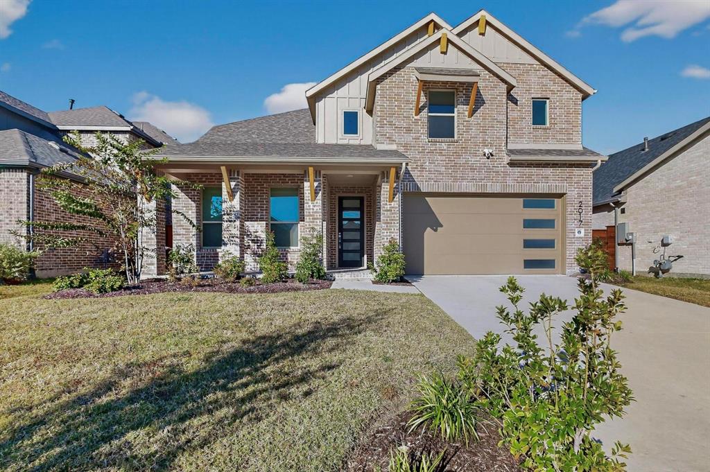 2017 Fall Crk Cove Mesquite, TX 75181 - Photo 1 of 40 View of front of home featuring driveway, board and batten siding, covered porch, brick siding, and a front yard