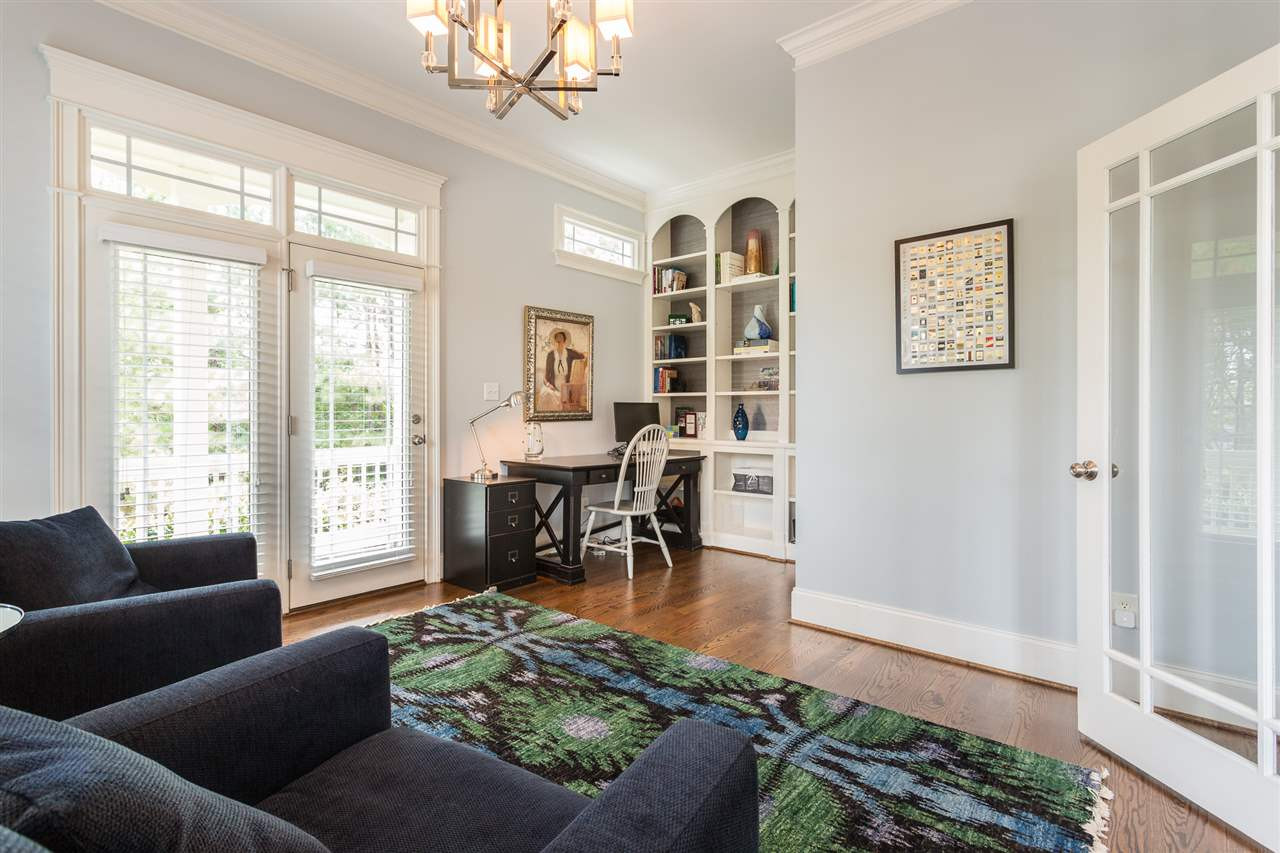 The study is truly a room you will want to spend time in as it offers direct access to the private side porch, floor-to-ceiling bookcases, double French glass doors, and hardwood floors. First Floor Study