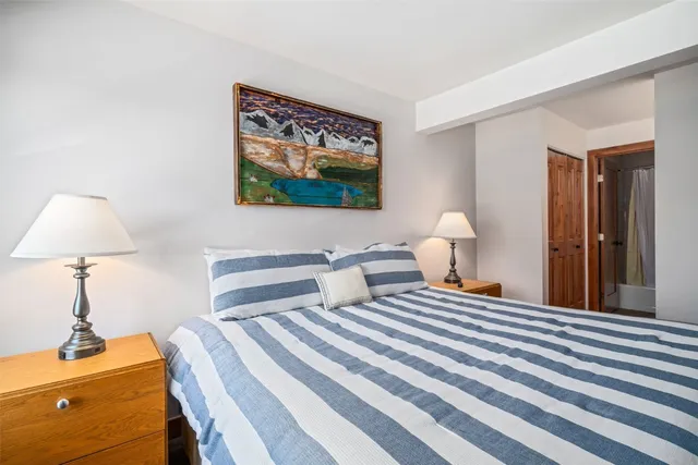 a bedroom with a bed and a lamp on table