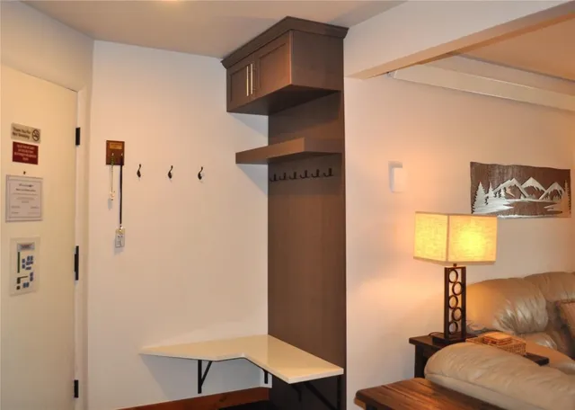 a view of a livingroom with furniture and a lamp