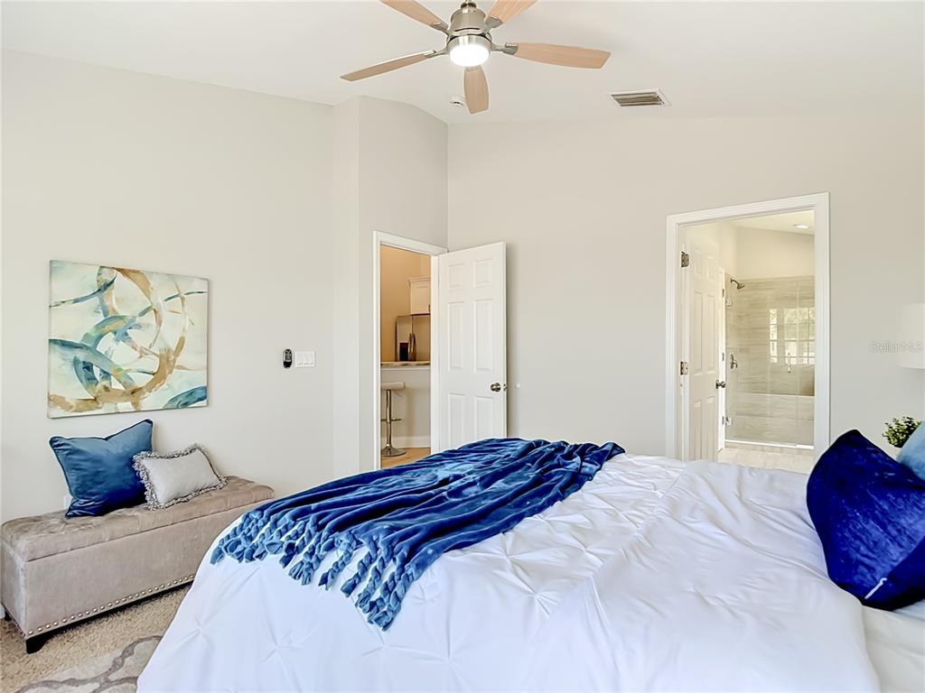 5310 Anhinga Trail New Port Richey, FL 34653 - Photo 16 of 27 a bedroom with a large bed and ceiling fan