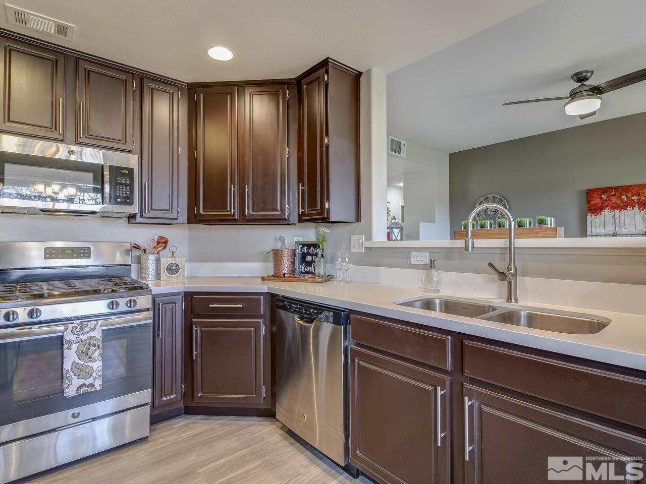 900 South, Unit 3714 Reno, NV 89521 - Photo 8 of 23 a kitchen with stainless steel appliances granite countertop a sink stove and cabinets