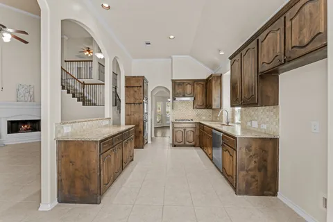 a spacious bathroom with a granite countertop sink and a mirror