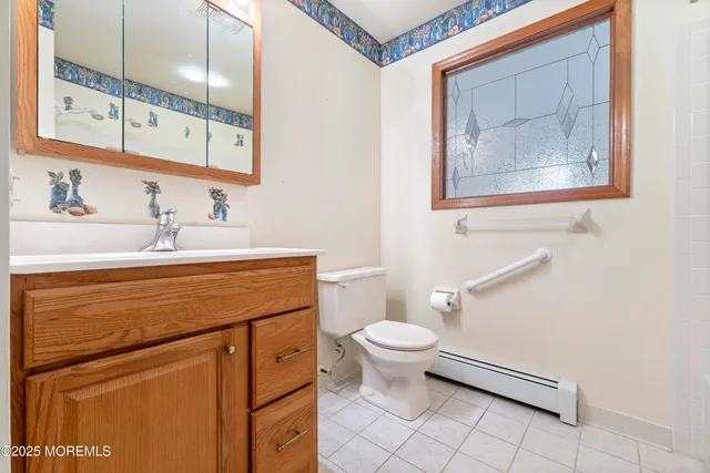 a bathroom with a sink toilet and mirror