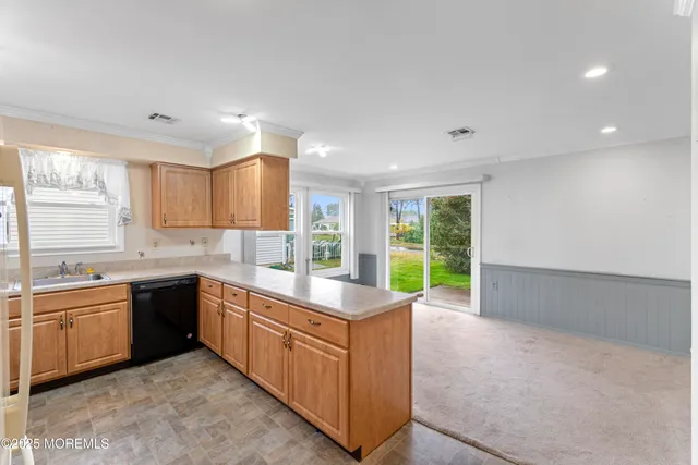 a large kitchen with kitchen island a sink dishwasher stove and cabinets