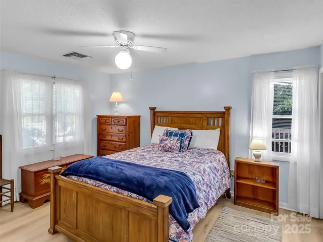 a bedroom with a bed and a night stand