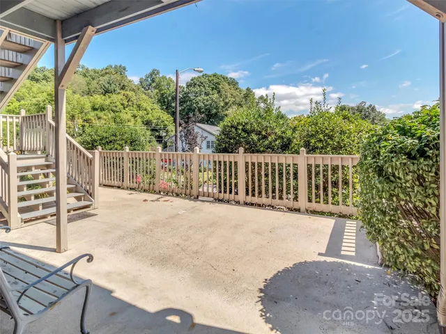 a view of a backyard with sitting area