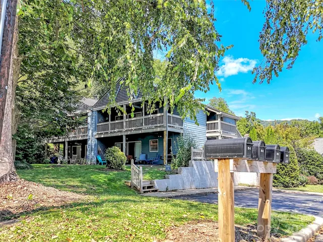 a front view of a house with a yard table and chairs