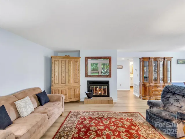 a living room with furniture window and a fireplace