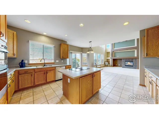 a open kitchen with stainless steel appliances granite countertop a sink counter space cabinets and a couch