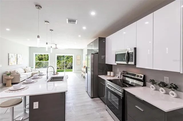 a kitchen with a sink stove and microwave