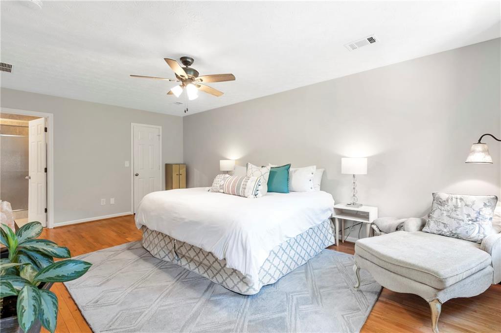 3167 Northbrook Drive Atlanta, GA 30341 - Photo 27 of 53 a bedroom with a bed mirror and a chandelier