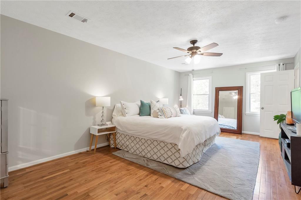 3167 Northbrook Drive Atlanta, GA 30341 - Photo 28 of 53 a bedroom with a large bed chandelier and a window