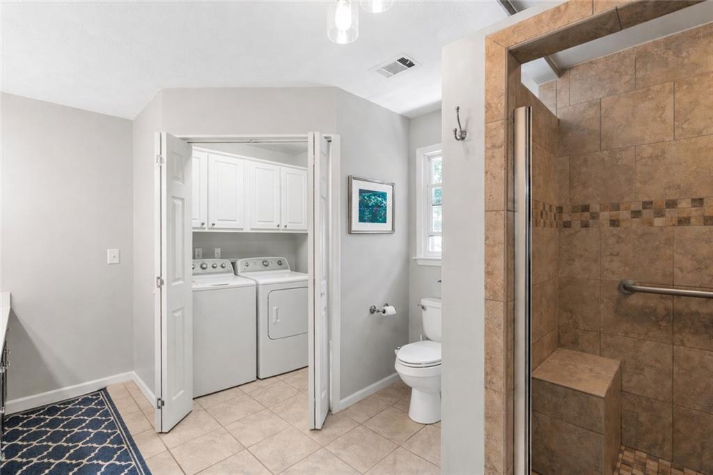 3167 Northbrook Drive Atlanta, GA 30341 - Photo 31 of 53 a bathroom with a granite countertop sink a toilet and shower
