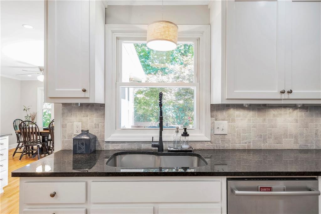 3167 Northbrook Drive Atlanta, GA 30341 - Photo 5 of 53 a kitchen with granite countertop white cabinets and a large window