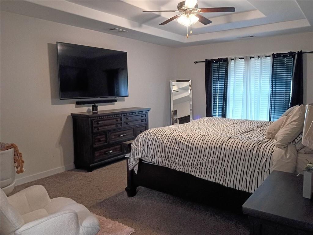 807 Ridgeview Court Hampton, GA 30228 - Photo 38 of 69 a spacious bedroom with a bed and a flat screen tv