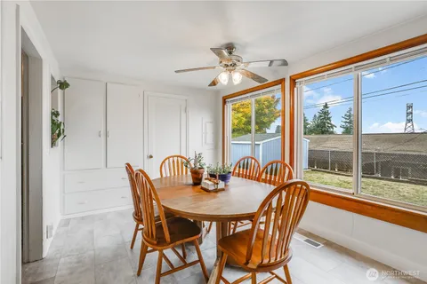 a view of a dining room with furniture a chandelier and wooden floor