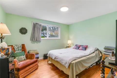 a bedroom with a bed and wall paintings