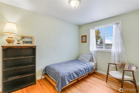 a bedroom with a bed and chair