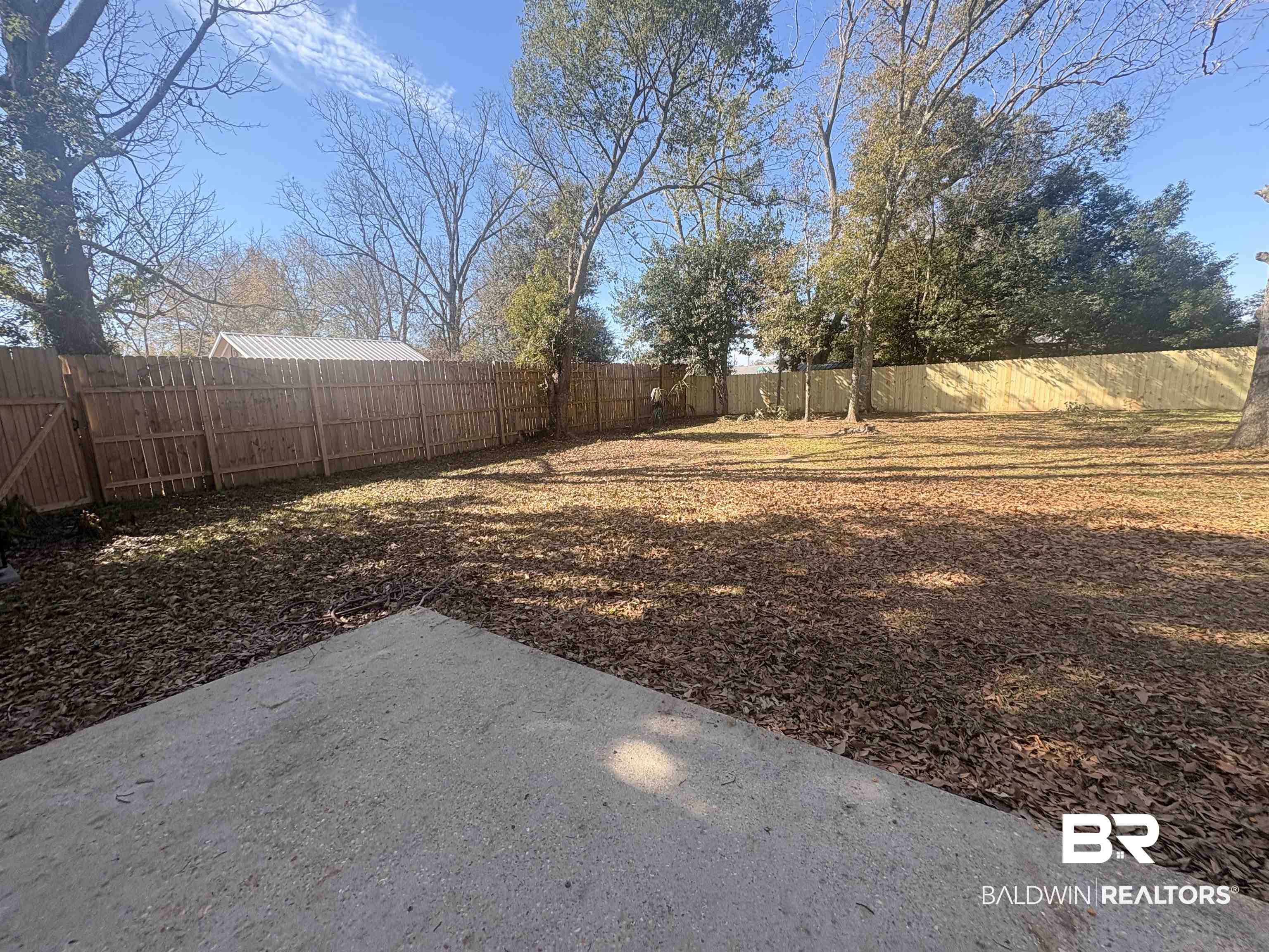 109-111 North Beech Street, Unit A & B Foley, AL 36535 - Photo 15 of 16 Fenced backyard with a patio area