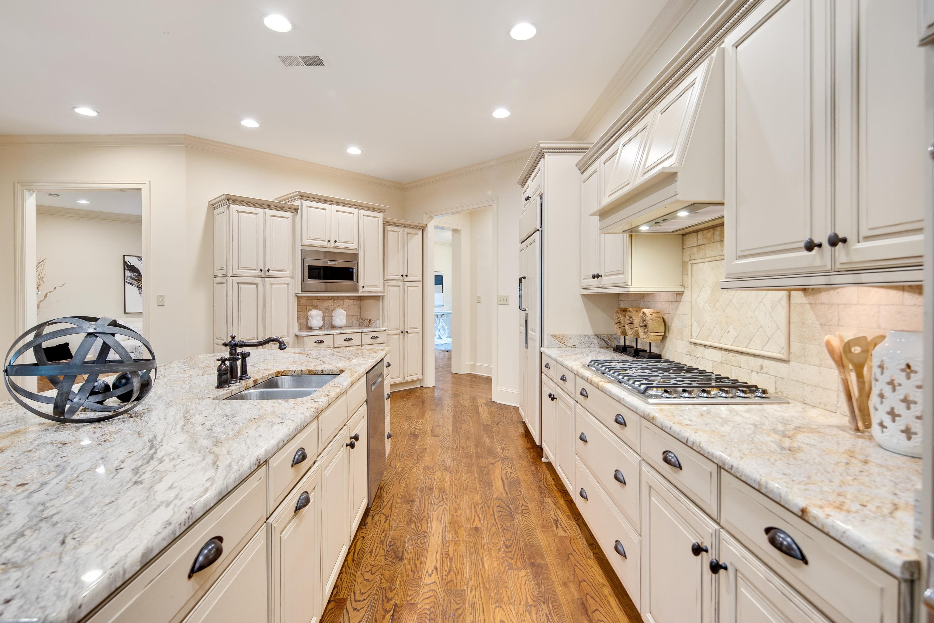 4938 Barfield Road Memphis, TN 38117 - Photo 11 of 40 a kitchen with stainless steel appliances granite countertop a sink stove and cabinets