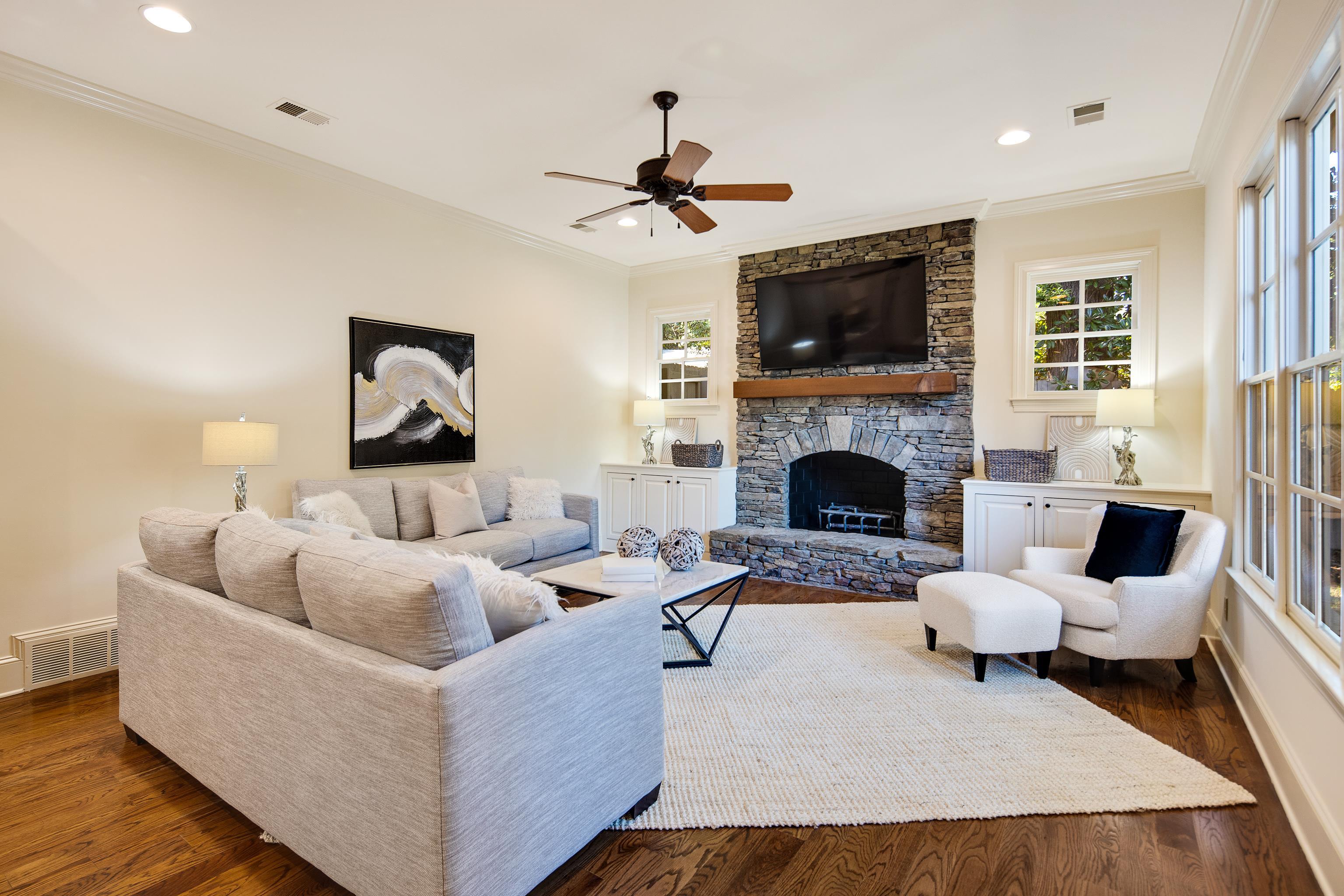 4938 Barfield Road Memphis, TN 38117 - Photo 12 of 40 a living room with furniture a flat screen tv and a fireplace