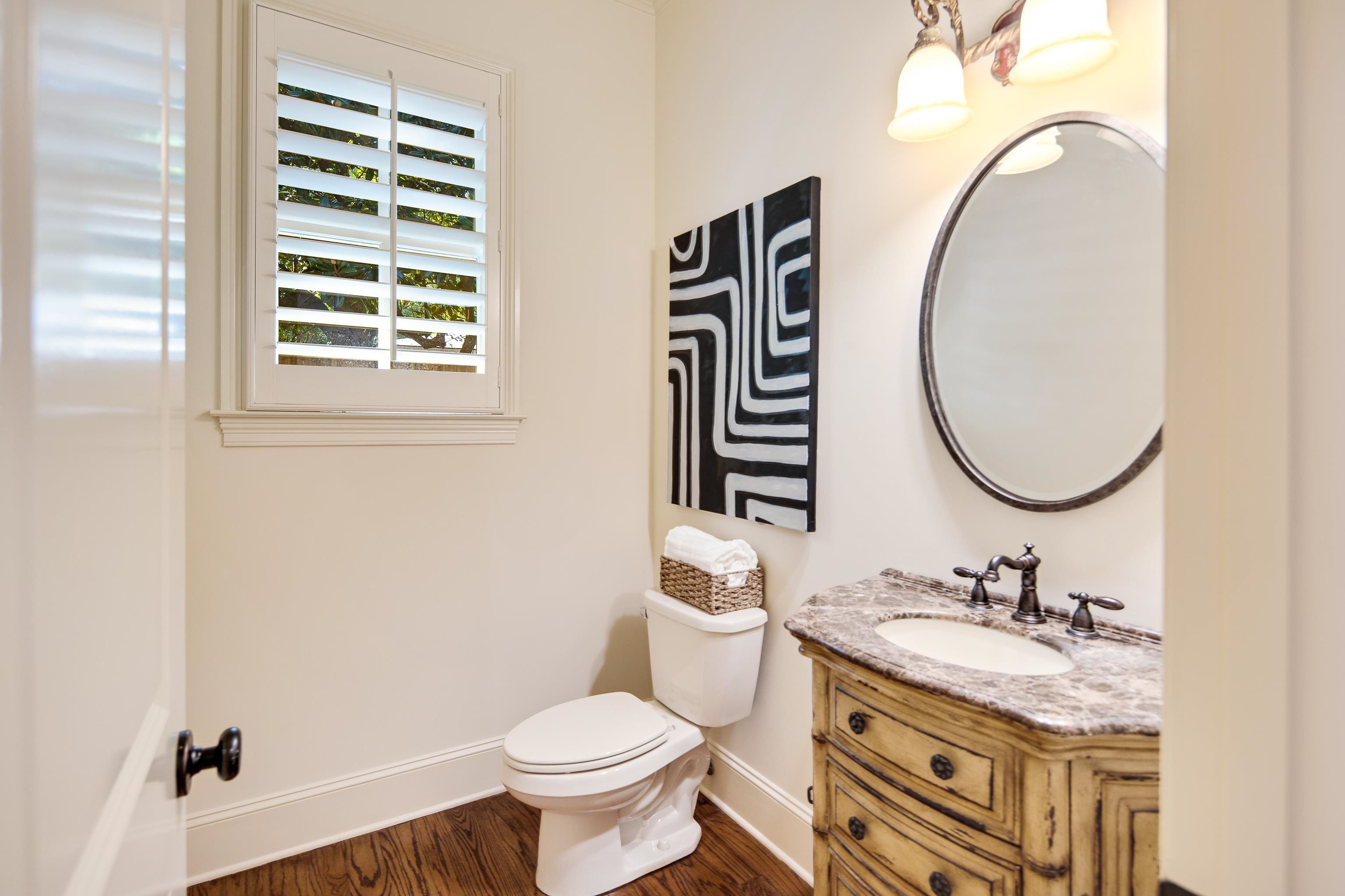4938 Barfield Road Memphis, TN 38117 - Photo 20 of 40 a bathroom with a granite countertop toilet a sink and a mirror