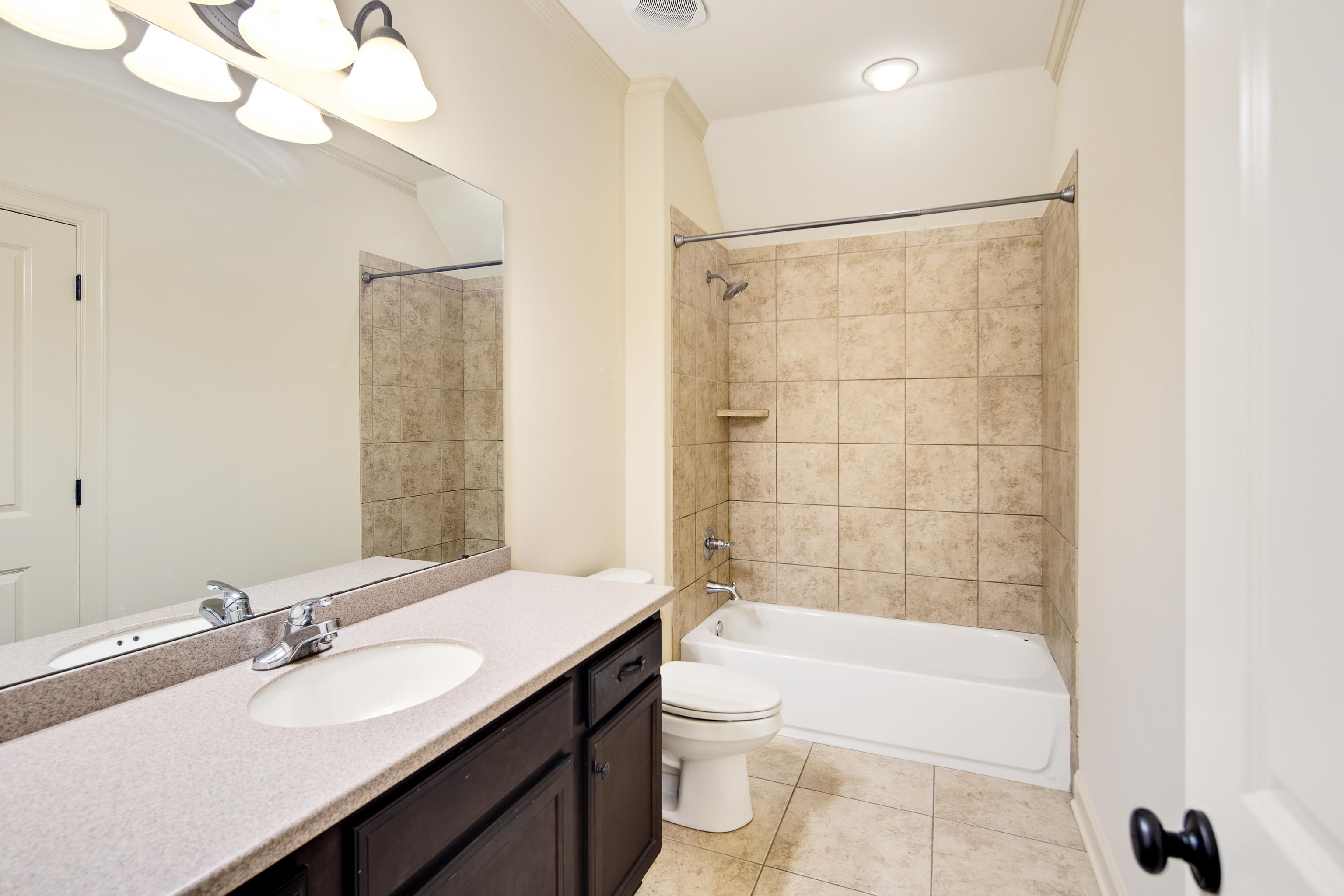 4938 Barfield Road Memphis, TN 38117 - Photo 26 of 40 a bathroom with a bathtub a sink a toilet a mirror and shower