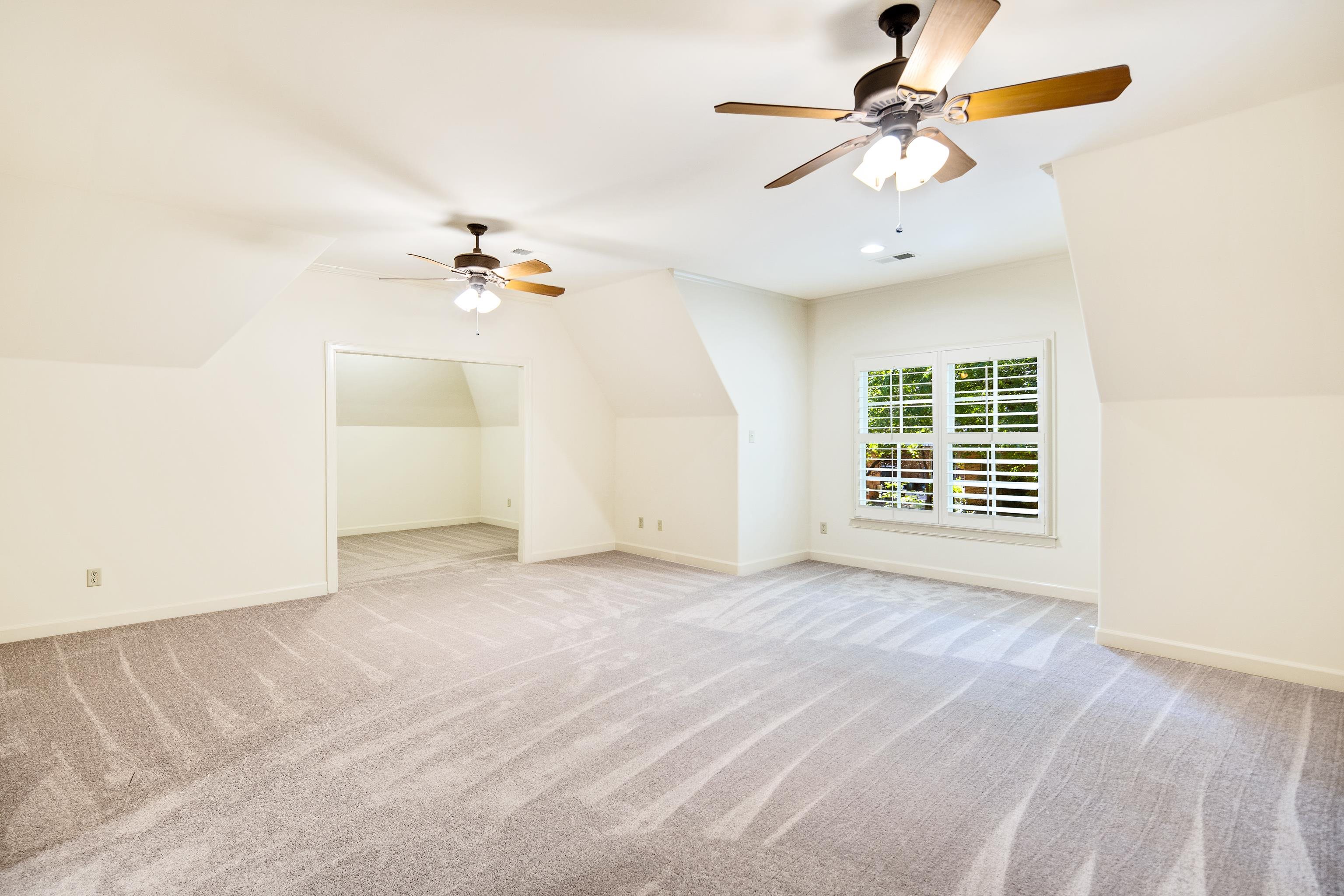 4938 Barfield Road Memphis, TN 38117 - Photo 27 of 40 an empty room with a window and a ceiling fan
