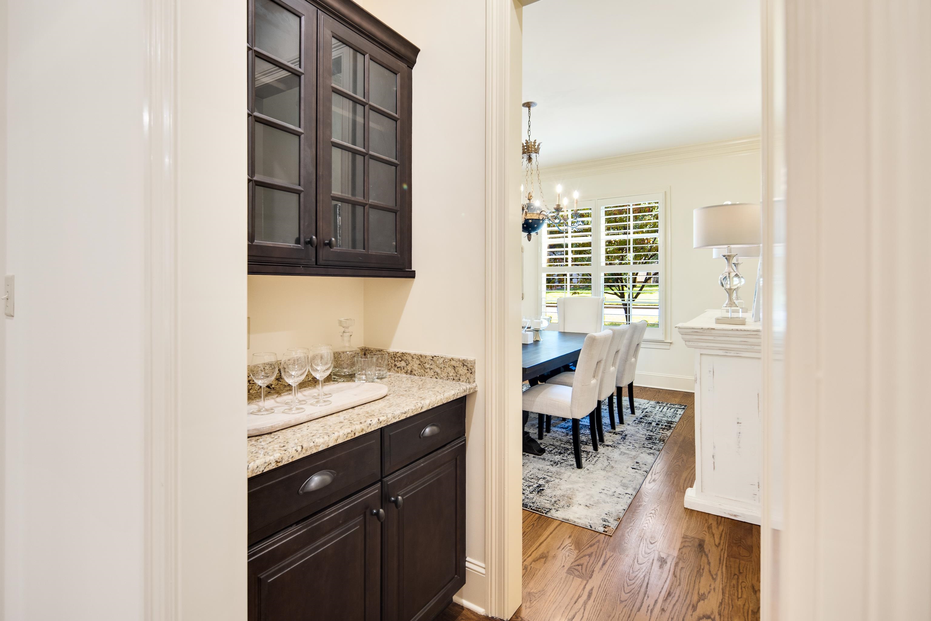 4938 Barfield Road Memphis, TN 38117 - Photo 5 of 40 a kitchen with a sink cabinets and dining table