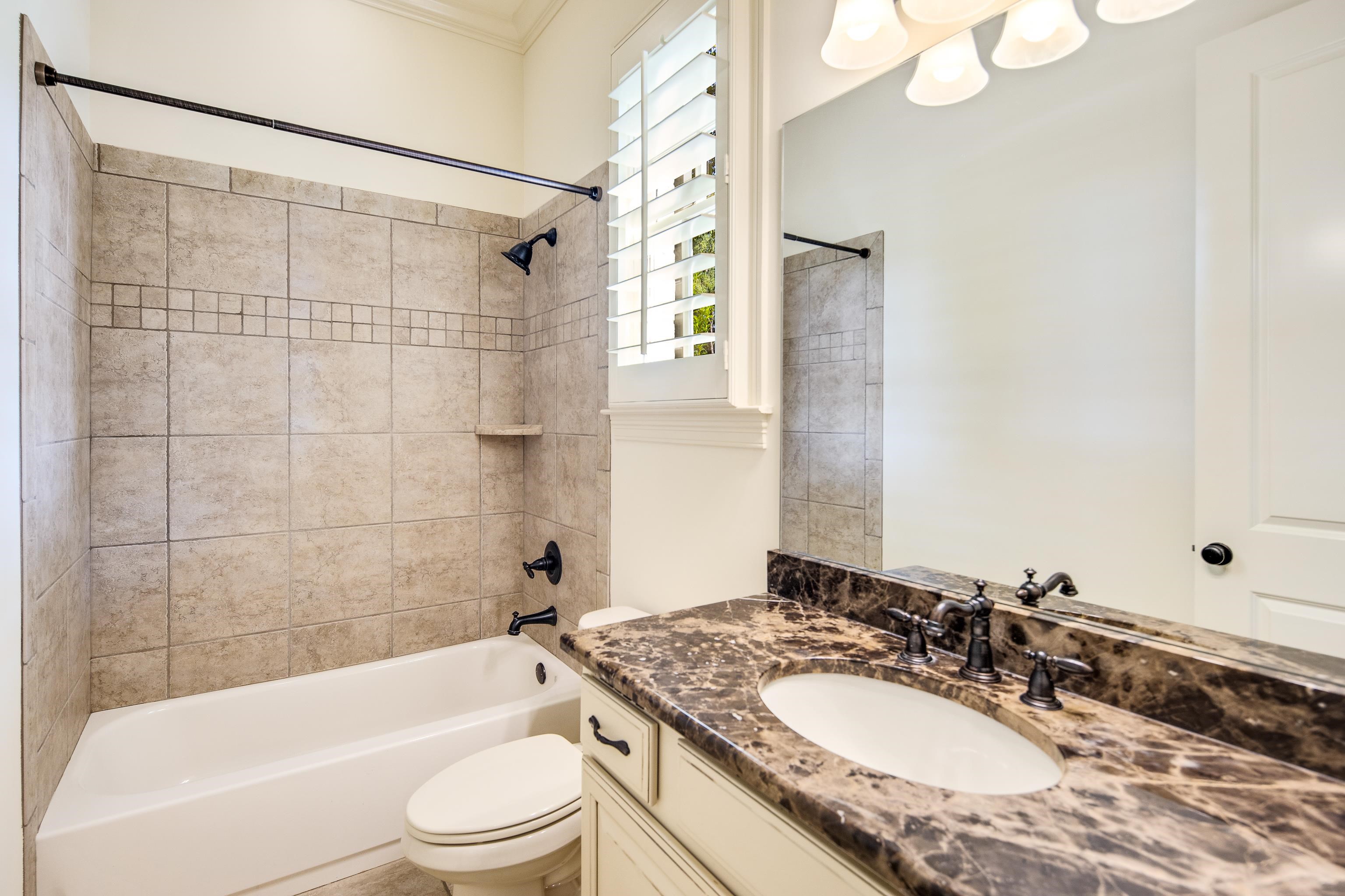 4938 Barfield Road Memphis, TN 38117 - Photo 6 of 40 a bathroom with a granite countertop sink toilet mirror and shower