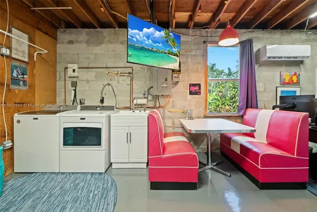 a utility room with stainless steel appliances kitchen island granite countertop furniture and a fireplace