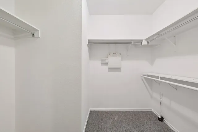 a view of walk in closet with empty racks