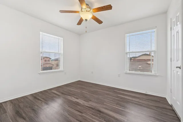 a view of room with hardwood floor and ceiling fan