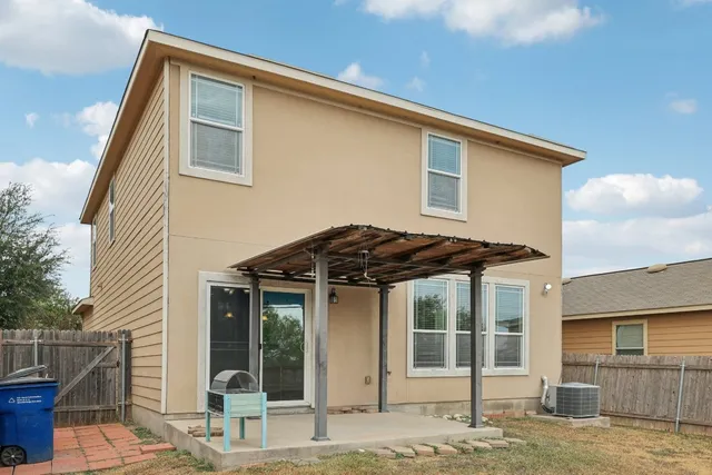 a backyard of a house with table and chairs