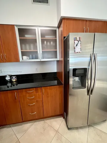 a kitchen with a refrigerator and a sink